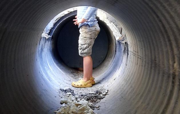 Boy in storm drain